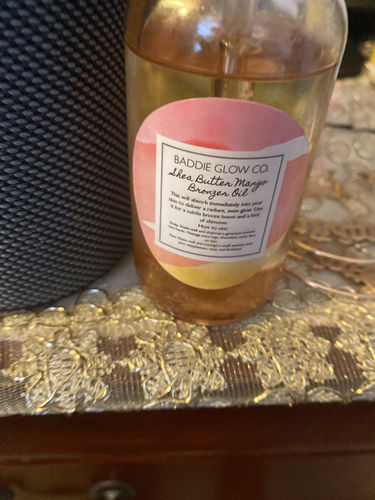 Customer photo review of BADDIE GLOW- SHEA MANGO ILLUMINATING BODY BRONZER OIL - 2 oz