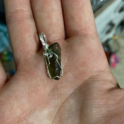 Customer photo review of Moldavite Pendant Necklace for Spiritual Awakening & Transformation.