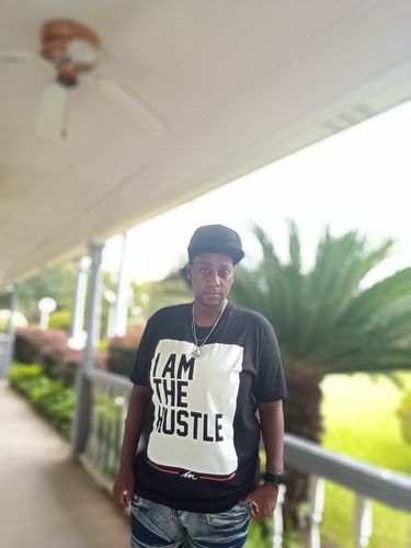 Customer photo review of I Am The Hustle Flag - Black Shirt