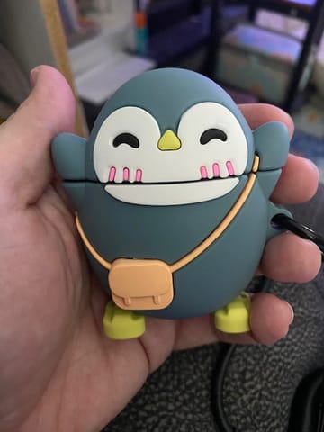 Customer photo review of Happy Penguin AirPods Case