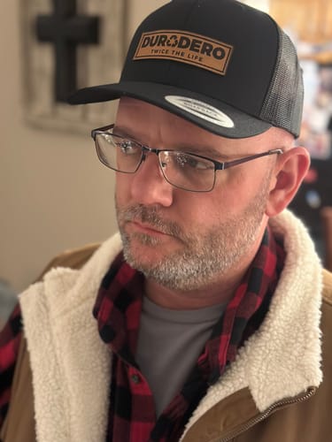 Customer photo review of Low Profile Embossed Leather Logo Trucker Hat Black