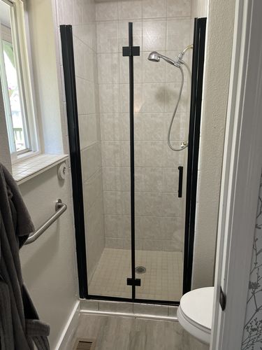 Customer photo review of SUNNY SHOWER 1/4 inch Bifold Shower Door with Semi-Frameless Clear Tempered Glass, Black Finish / Chrome Finish