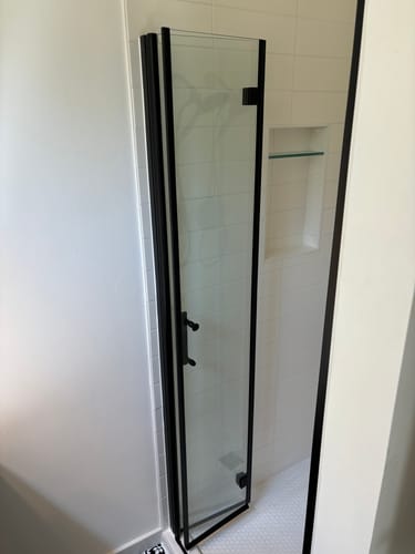 Customer photo review of SUNNY SHOWER 1/4 inch Bifold Shower Door with Semi-Frameless Clear Tempered Glass, Black Finish / Chrome Finish