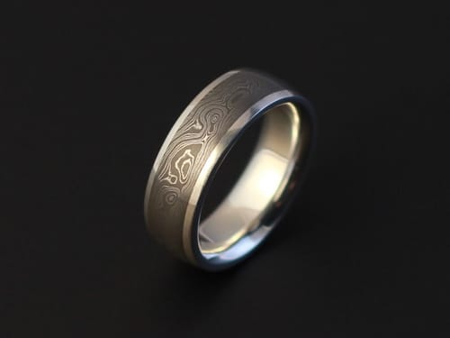 Customer's forged damascus ring with a patterned finish, made using the aluminum oxide sanding belts.