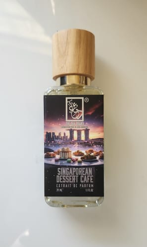 Customer's bottle of Singaporean Dessert Cafe perfume, featuring a wooden cap and illustrated label.