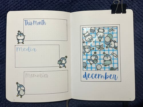 Customer's journal spread for December decorated with cute Party Penguin stickers from the Sticker Subscription.