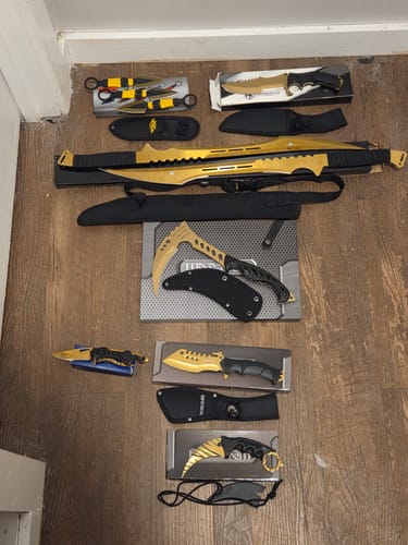 Customer's 10 Piece Ultra-Gold Mega Knife Set displayed on a floor, showing the various gold knives and black sheaths.