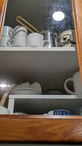 Customer shows a greasy, smeared glass cabinet door before cleaning with the KoalaCloth.