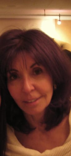 Close-up of a reviewer's smiling face, showing hydrated skin after using the Grass Fed Tallow & Honey Balm.