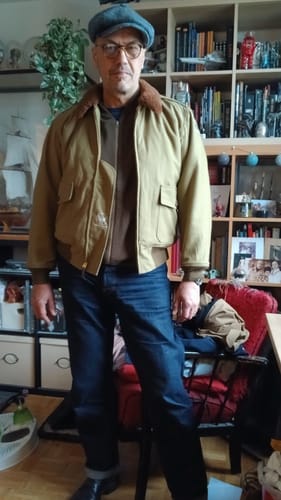 Customer wearing the khaki USAAF Type B-10 Flight Jacket unzipped indoors, showing the full fit and fur collar.
