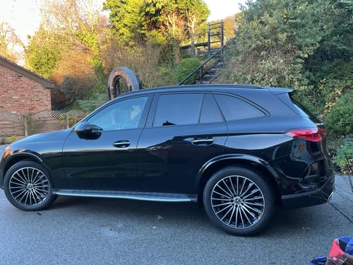 Reviewer's shiny black SUV parked in a driveway, showing the results from using the HYDRO DRYING TOWEL.