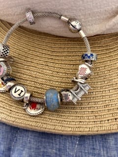 Customer's charm bracelet on a woven hat, showing a light blue Solid Color Bead.