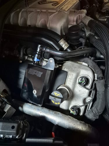 Reviewer's black SPE Billet Oil Separator Catch Can showing a clean installation in a GT500 engine bay.
