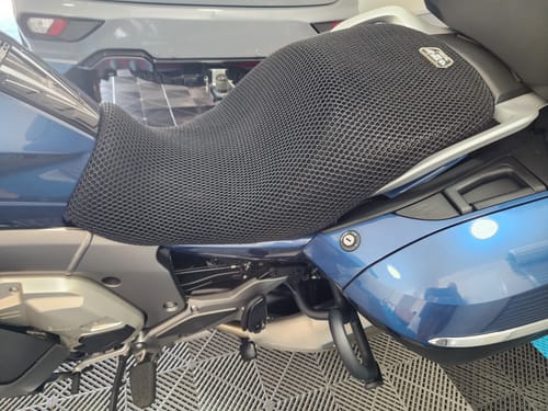 Customer's black mesh Wind Rider Seat Cover fitted on a blue motorcycle, adding height to the seat.
