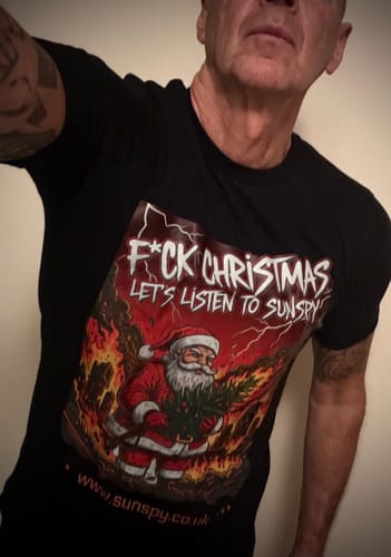 Customer wearing a black Unisex fashion fit t-shirt with a large custom graphic of Santa Claus in front of flames.