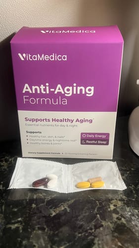 Customer's purple box of Anti-Aging Formula, with the daily vitamins opened from their packet.