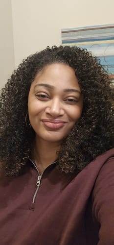 Customer smiling, showing the natural-looking texture and volume of their Outre Quick Weave Half Wig - AURAYNA.