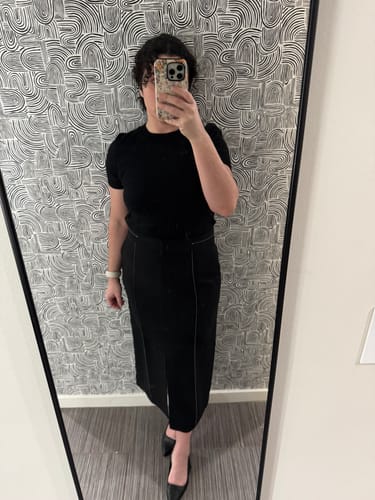 Reviewer wearing the black Meghan Midi Skirt, showing the contrast topstitching detail.