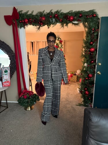 Reviewer in a festive setting wearing the Houndstooth Plaid Suit Blazer and matching pants.