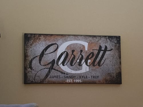 Customer's rustic Family Last Name Sign, personalized with 'Garrett' and family details, hanging on a wall.