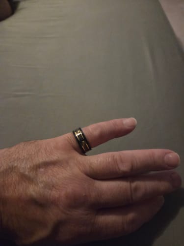Customer showing a close-up of the black and gold Titanfall ring on their hand.