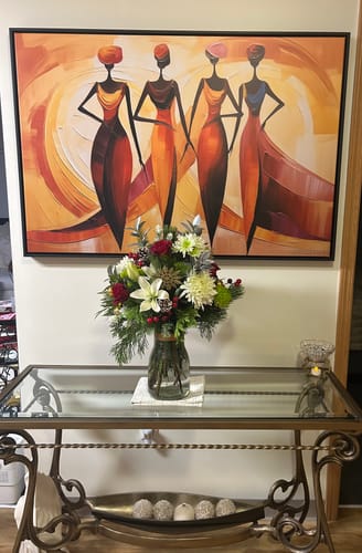 Reviewer's Golden Maroon Elegance canvas with a black floating frame, hanging on a white wall above a console table.