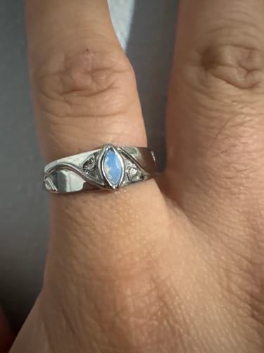 Customer wearing the June Birthstone Ring, showing the opalescent marquise-cut stone and detailed silver band on their finger.