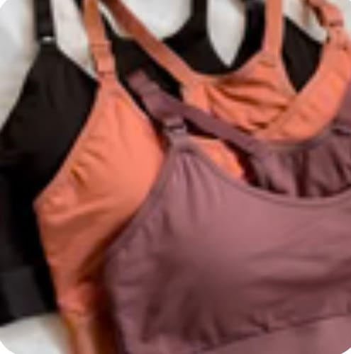 Close-up: Customer's Skye Pump Bras in black, coral, and dusty rose, showing the adjustable straps.