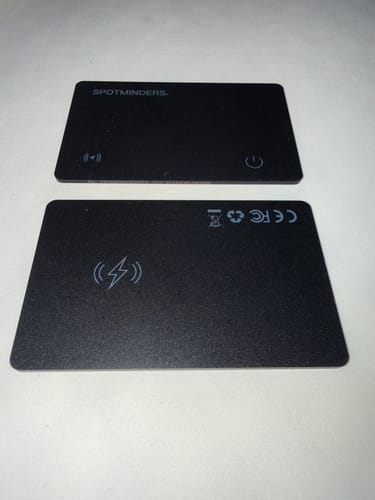 Customer showing the front and back of their two black SPOTMINDERS Tracking Cards.