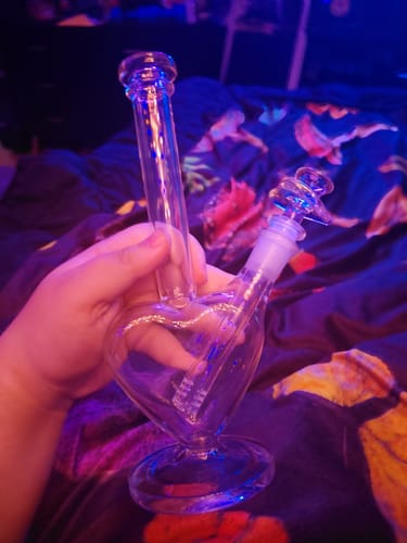 Customer holding the clear glass Perfect Heart Bong in their hand.