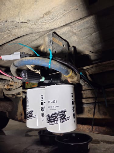 Customer's Universal Electric Diesel Fuel Heater Kit installed on a fuel pump system under a truck.