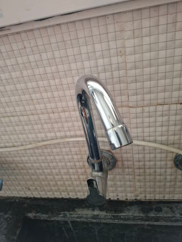Customer's shiny chrome tap on a tiled wall after being cleaned with the Limescale Remover.