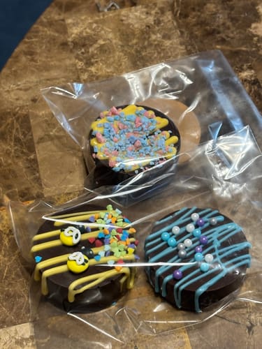 Customer photo of three decorated, round treats in plastic bags; Bully Bites not visible.
