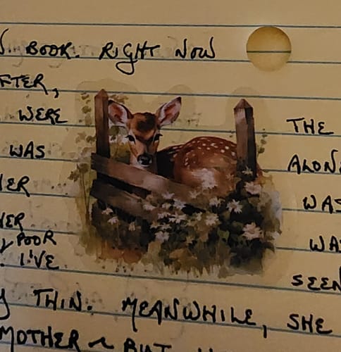 A customer's Forest Fall Animal Sticker of a baby deer resting behind a fence on a handwritten page.