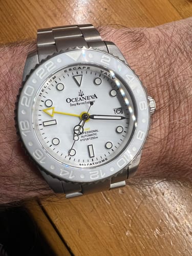 Customer wearing their Oceaneva Deep Marine Explorer watch, showing the white face and titanium bracelet on their wrist.