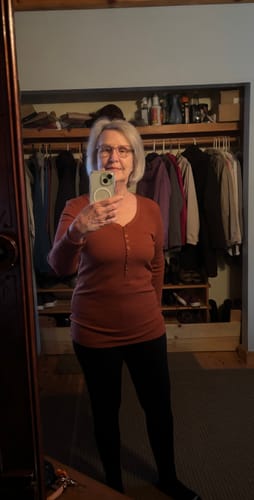Reviewer's mirror selfie showing the fit of the black, full-length Stella Leggings.