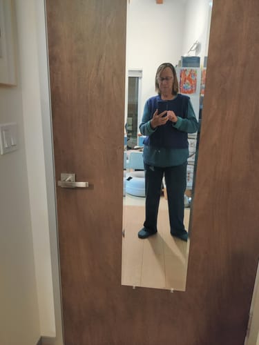 Reviewer taking a full-length mirror selfie wearing the relaxed-fit Luca Ribbed Pants in Majolica Blue.