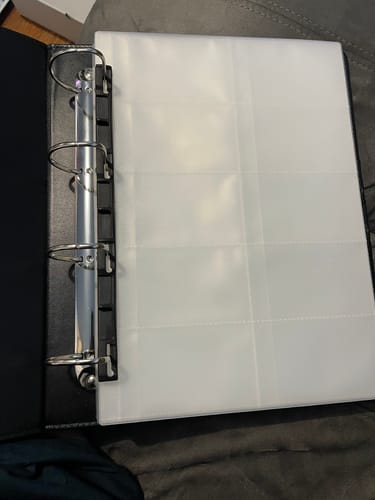 Customer's A4 page protector sheet inserted into an open black 4-ring binder.