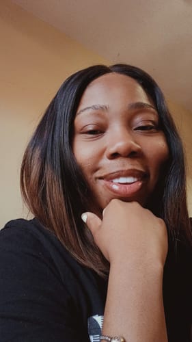 A close-up of a customer smiling, showing her teeth with the custom Pop On Veneers.