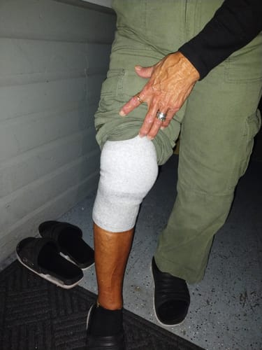 Customer wearing the comfortable, light grey Premium Bamboo Knee Sleeve on their knee.