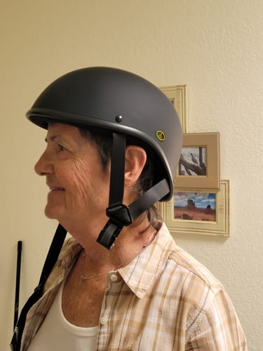 Customer's side view wearing the matte black Maltese DOT SOA Limited Edition helmet indoors.