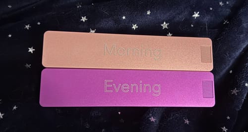 Customer's Weekly AM-PM Vitamin XL Case 2.0 with the closed rose gold 'Morning' and purple 'Evening' sections on a blanket.