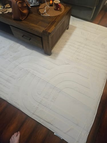 Reviewer's Mellow Mat in Vanilla Cream showing the carved 3D pattern on a living room floor.
