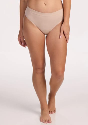 Reviewer standing in the sand-colored Maeve Bikini, showing the seamless front fit against a white background.