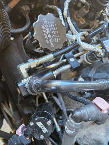 Reviewer's black SPE Motorsport 16-Quart Billet Oil Cap installed in a truck's engine bay.
