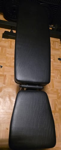 Rezensent zeigt die schwarze verstellbare Hantelbank B4 in flacher Position von oben.