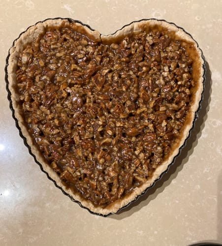 Reviewer's delicious, heart-shaped pie made with Raw Pecans on a kitchen counter.
