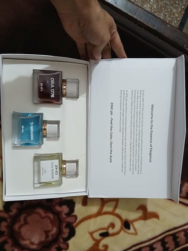 Customer opening the OUD Supreme BUNDLE box, showing three different fragrance bottles inside.