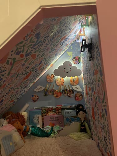 Reviewer's black X-acto Knife mounted on the wall of a child's decorated reading nook.