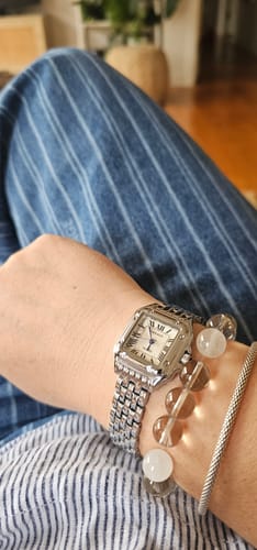 Customer wearing the silver GREALY DE MAINS watch on their wrist, styled with a beaded and a silver bracelet.